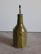 Faceted large oil pourer in moss green glaze with a steel pouring spout