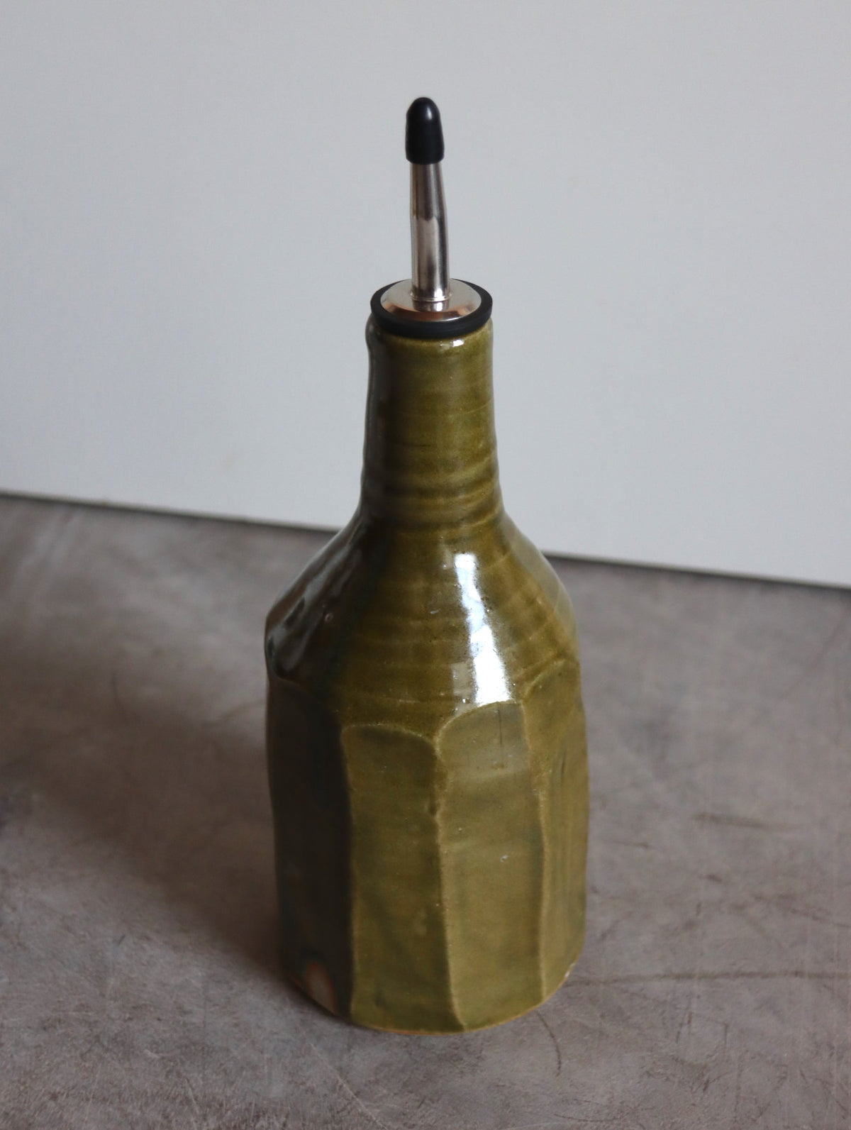 Moss green faceted oil pourer by Hannah Burgess Ceramics, third view